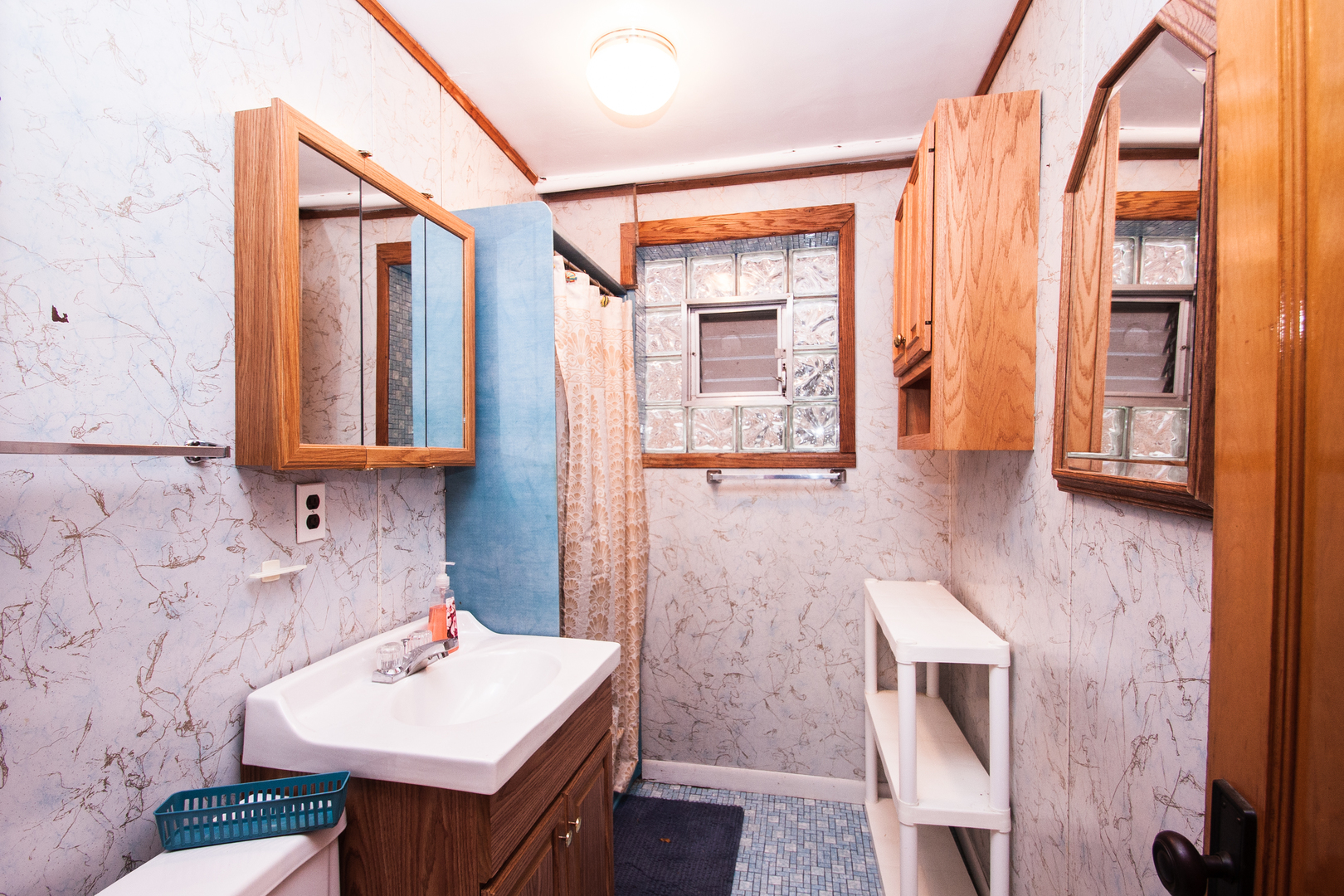3909 North Spaulding Avenue Chicago, IL 60618 - Photo 18 of 20 a bathroom with a sink a mirror and a shower