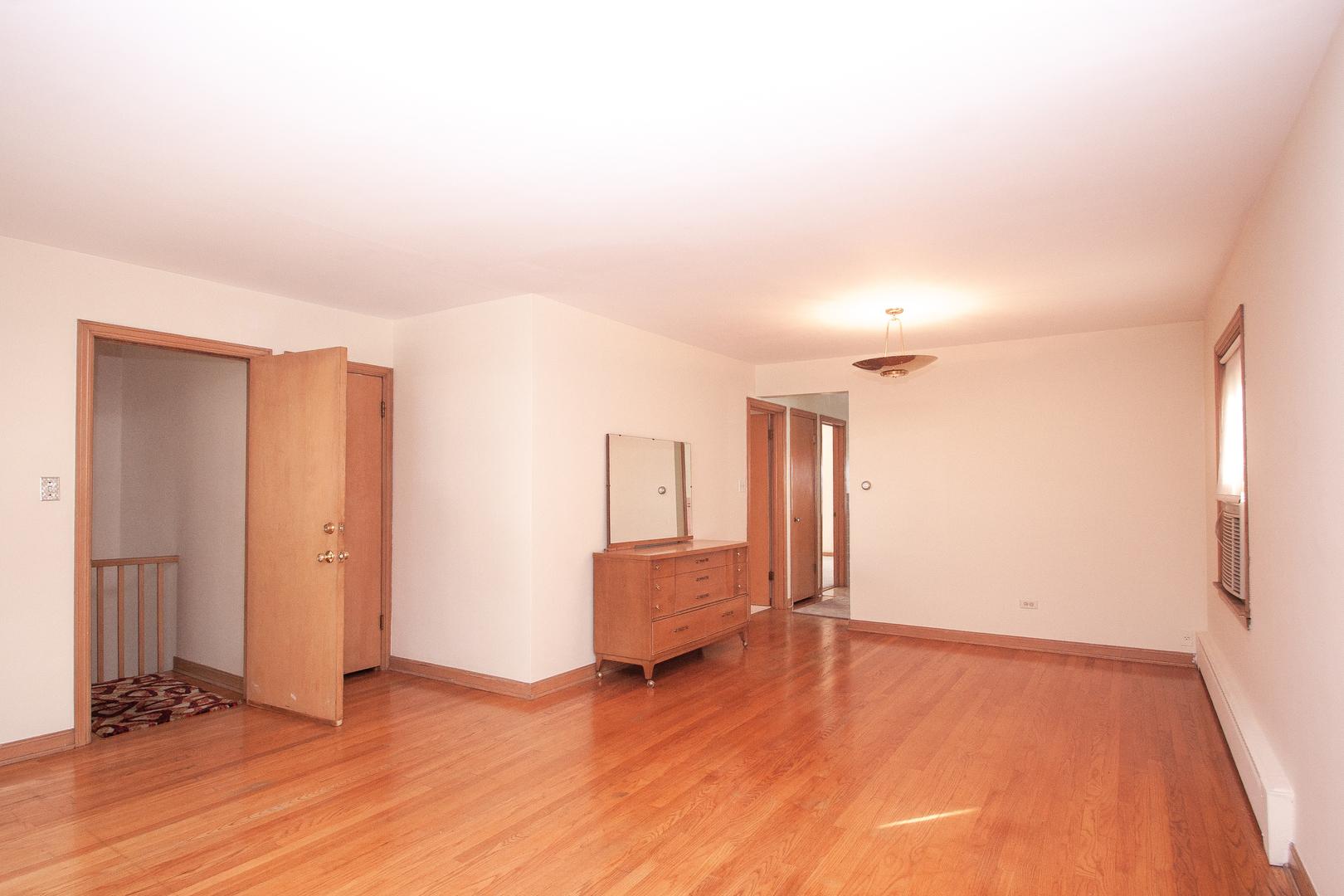 3909 North Spaulding Avenue Chicago, IL 60618 - Photo 3 of 20 an empty room with wooden floor and windows