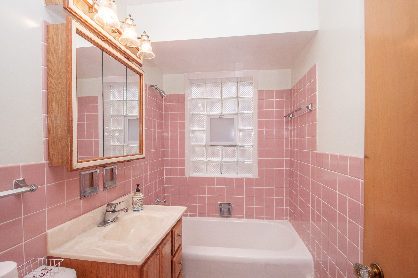 3909 North Spaulding Avenue Chicago, IL 60618 - Photo 8 of 20 a bathroom with a bathtub a sink a vanity and a shower