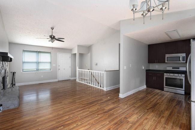 8955 Ochil Lane Winston, GA 30187 - Photo 11 of 31 a view of a kitchen and an empty room with wooden floor and a window