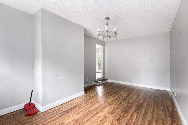 8955 Ochil Lane Winston, GA 30187 - Photo 15 of 31 a view of an empty room with wooden floor and a window