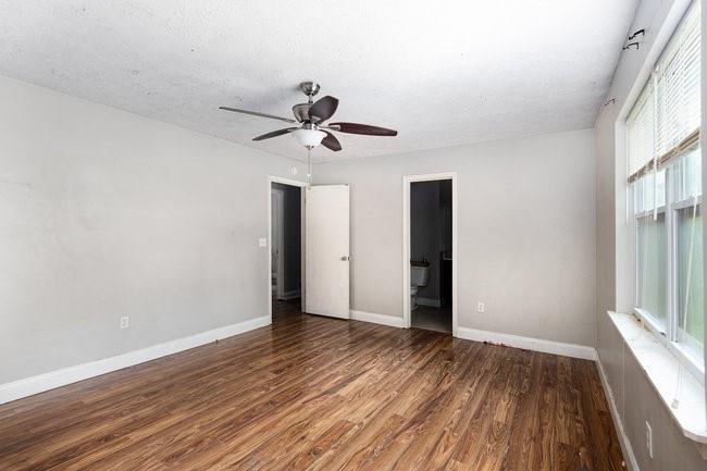 8955 Ochil Lane Winston, GA 30187 - Photo 19 of 31 a view of an empty room with wooden floor and a window