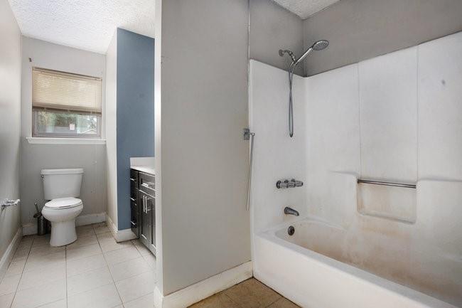 8955 Ochil Lane Winston, GA 30187 - Photo 20 of 31 a bathroom with a bathtub and a toilet