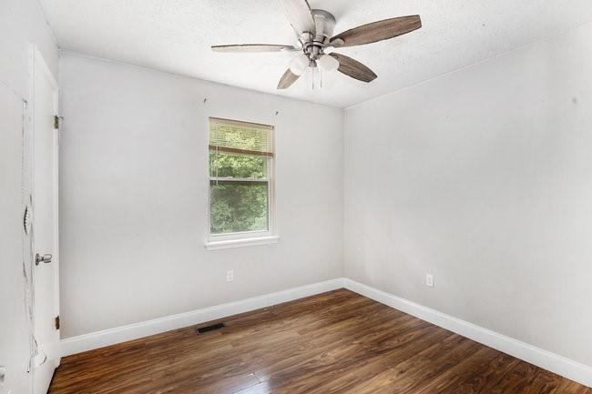 8955 Ochil Lane Winston, GA 30187 - Photo 22 of 31 wooden floor in an empty room with a window