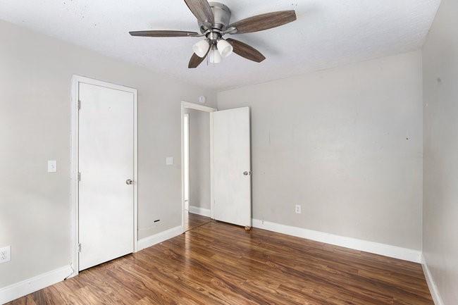 8955 Ochil Lane Winston, GA 30187 - Photo 25 of 31 an empty room with wooden floor ceiling fan and window