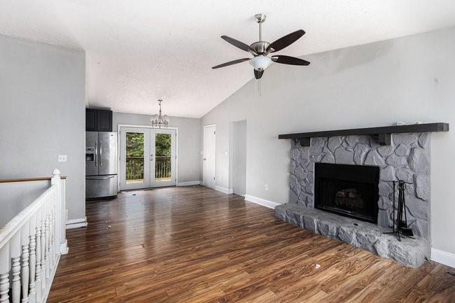 8955 Ochil Lane Winston, GA 30187 - Photo 5 of 31 a view of a livingroom with wooden floor and a fireplace