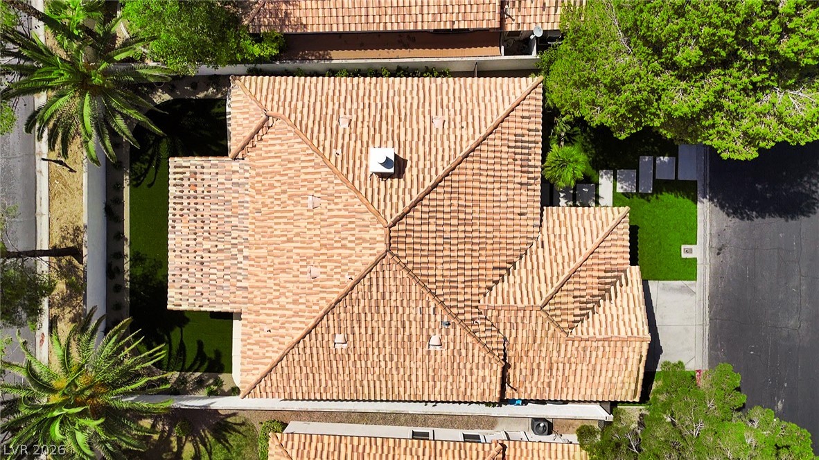 8981 Rivers Edge Drive Las Vegas, NV 89117 - Photo 60 of 69 An aerial perspective reveals the home's distinctive tile roof, surrounded by mature trees and verdant lawns.