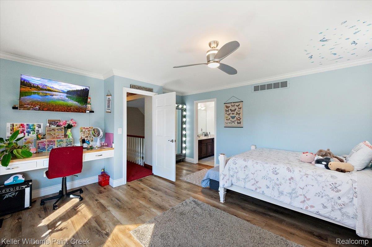 69069 Campground Road Romeo, MI 48065 - Photo 53 of 78 Spacious room featuring wood-finish flooring, crown molding, and a contemporary ceiling fan