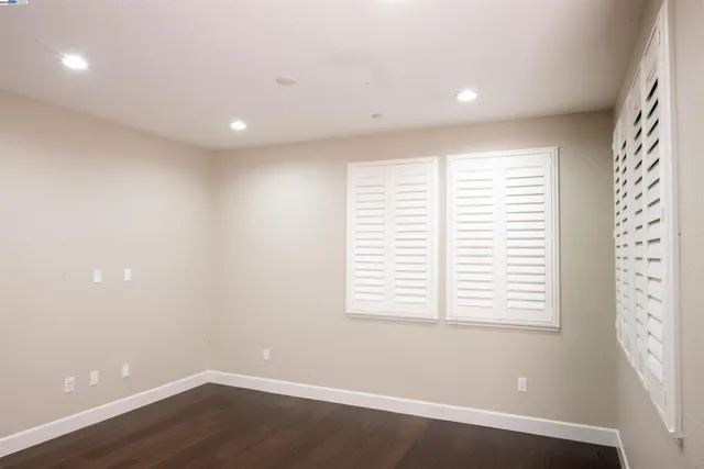 a view of a room with wooden floor and window