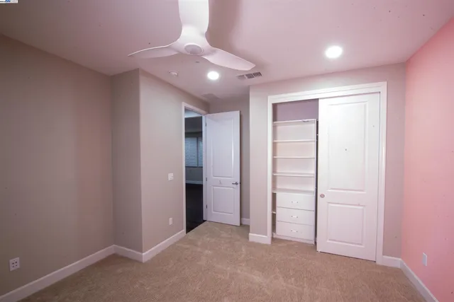 an empty room with closet area