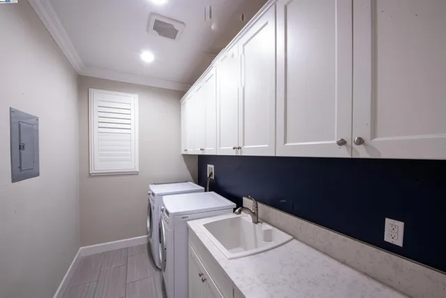 a room with a sink cabinets and wooden floor