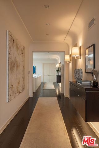 a spacious bedroom with a bed and lamp