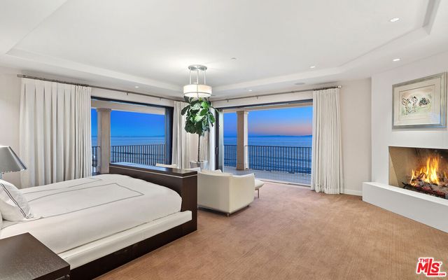 a large bathroom with a glass door shower and sink
