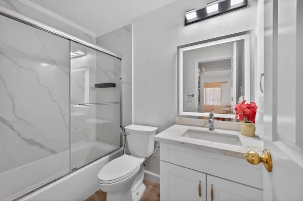 a bathroom with a sink toilet and shower
