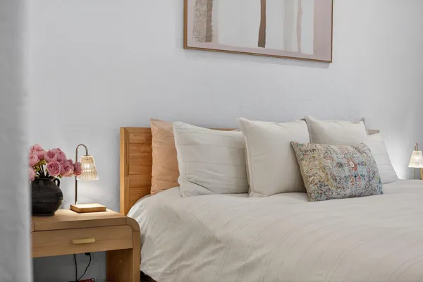 a bedroom with a bed and a table