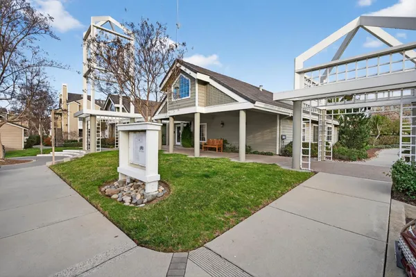 a view of a house with swimming pool and sitting area