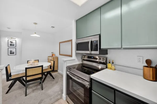 a kitchen that has a sink and a stove top oven