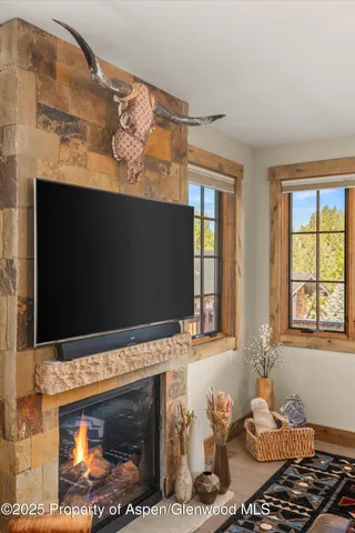 a living room with a fireplace and a flat screen tv