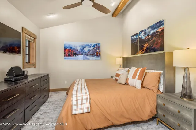 a bed room with a bed and a flat screen tv