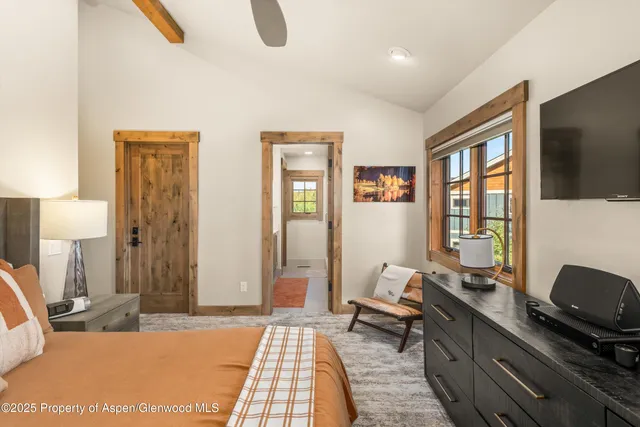 a bedroom with furniture and a window