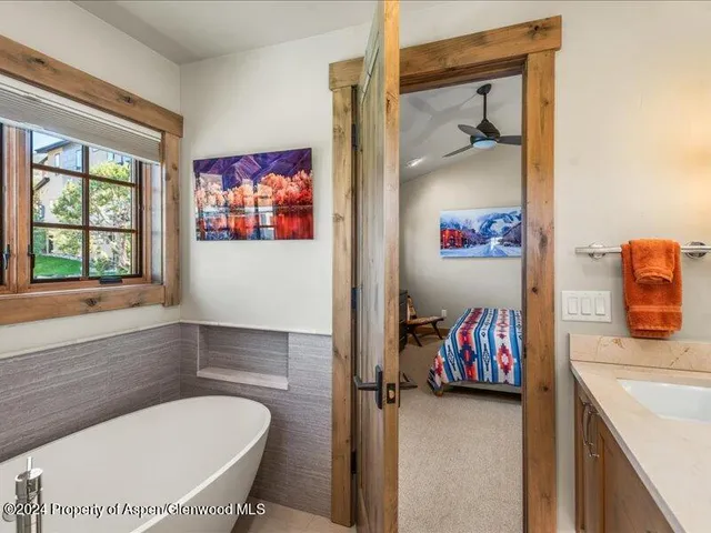 a en suite bathroom with a granite countertop tub and a window
