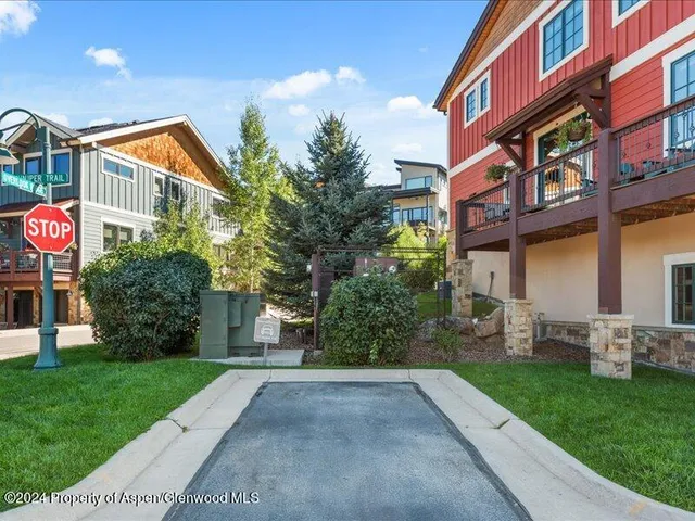 a street sign on a brick wall in front of a building