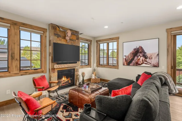 a living room with furniture fireplace and flat screen tv