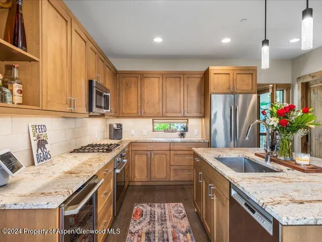 a kitchen with a sink stove and refrigerator