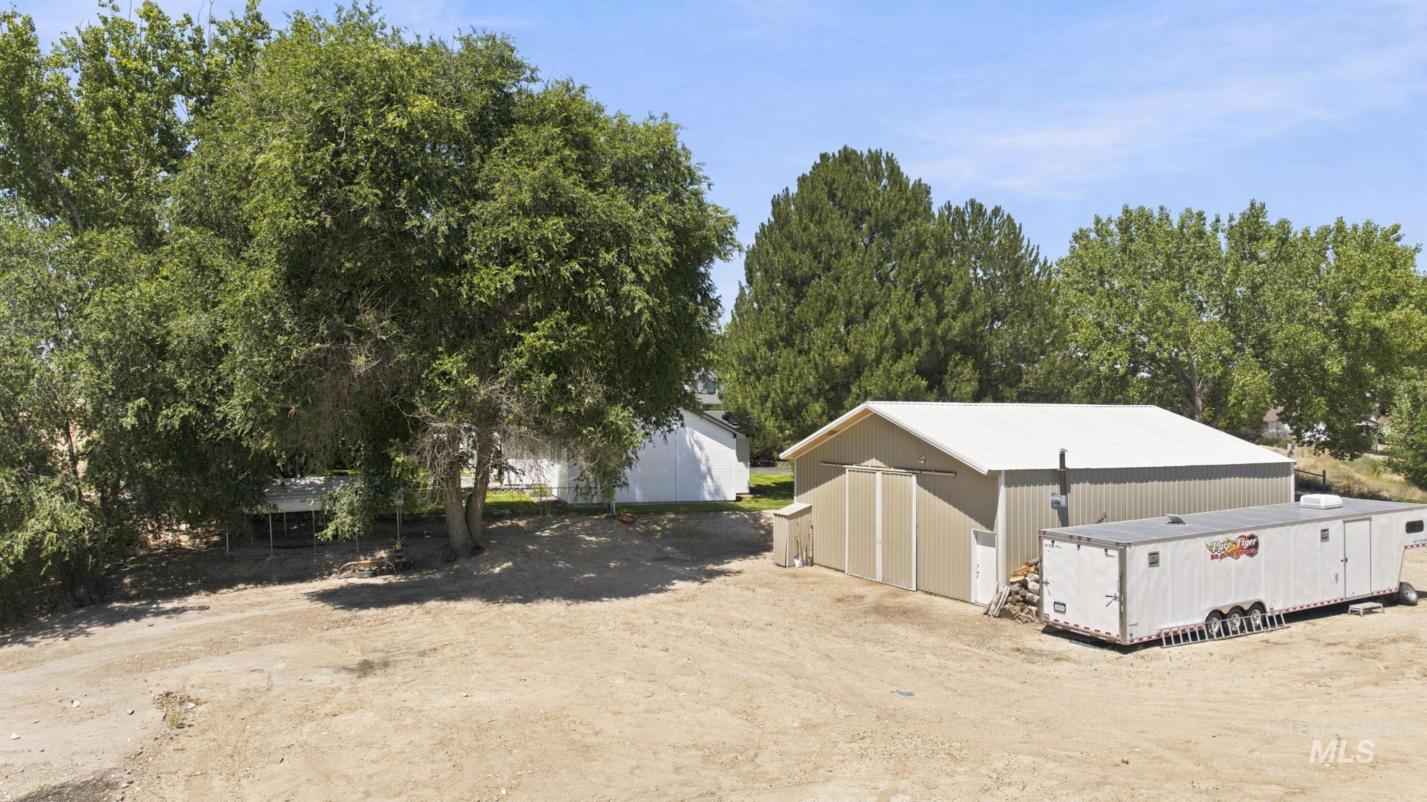 24864 Coventry Drive Caldwell, ID 83607 - Photo 4 of 49 Large metal building with tan siding and a light-colored roof