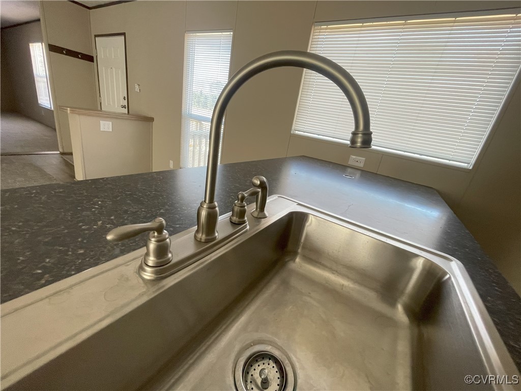 26286 Peters Bridge Road Courtland, VA 23837 - Photo 23 of 32 Interior details with sink and dark stone counters
