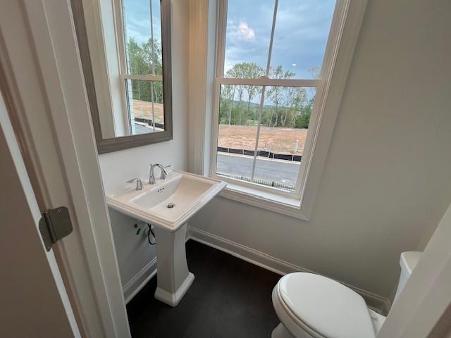 635 Silva Street, Unit 131 Cumming, GA 30040 - Photo 19 of 67 a bathroom with a sink a toilet a mirror and a window