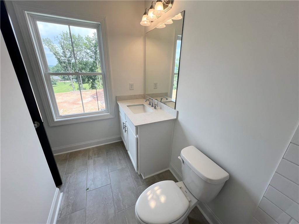 635 Silva Street, Unit 131 Cumming, GA 30040 - Photo 42 of 67 a bathroom with a sink toilet and mirror