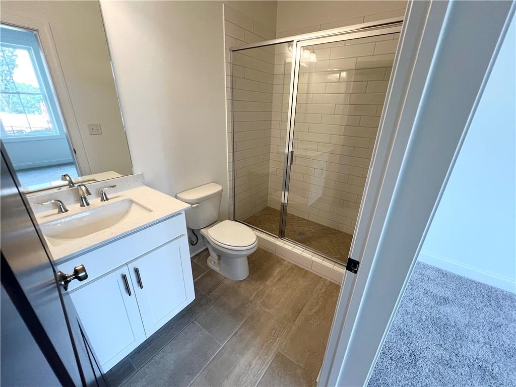 635 Silva Street, Unit 131 Cumming, GA 30040 - Photo 49 of 67 a bathroom with a sink a toilet and shower