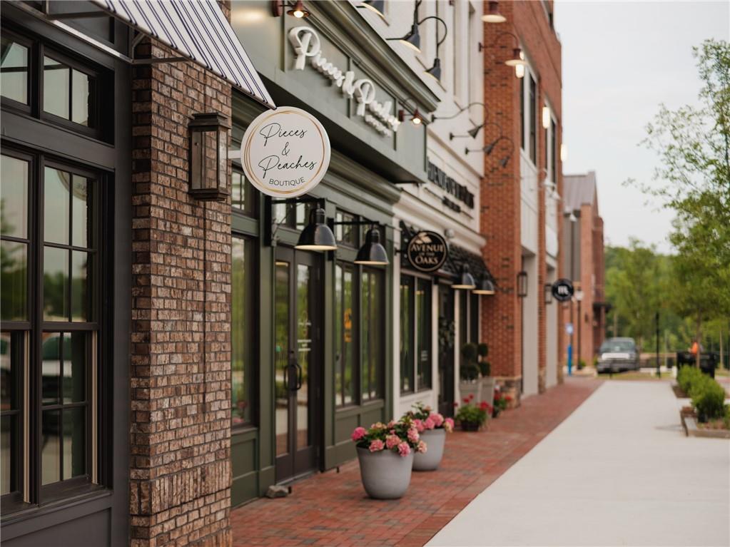 635 Silva Street, Unit 131 Cumming, GA 30040 - Photo 64 of 67 a view of a brick building with a clock on the wall