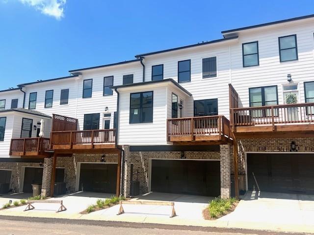 635 Silva Street, Unit 131 Cumming, GA 30040 - Photo 9 of 67 a front view of a house with a garage