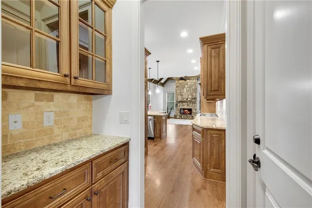 a spacious bathroom with a granite countertop sink a mirror a shower and a bathtub
