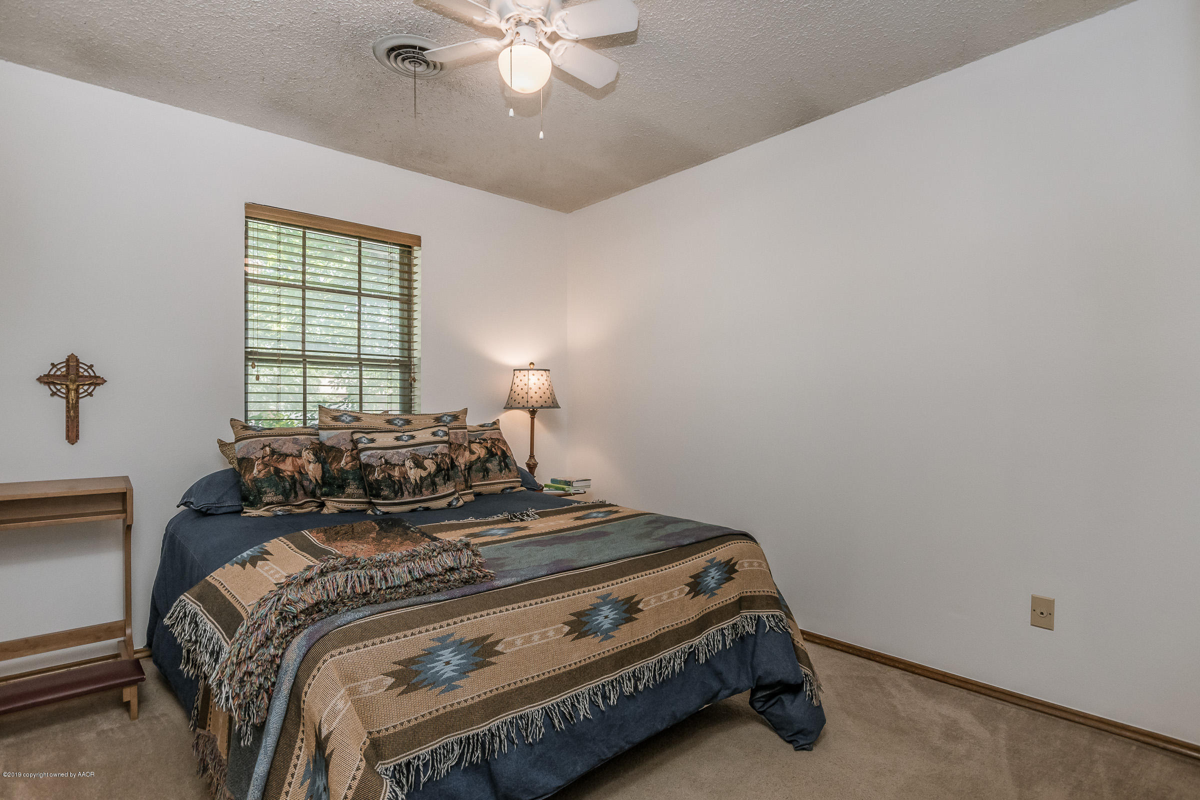 5264 Capulin Lane Amarillo, TX 79110 - Photo 13 of 22 a bed sitting in a bedroom next to a window