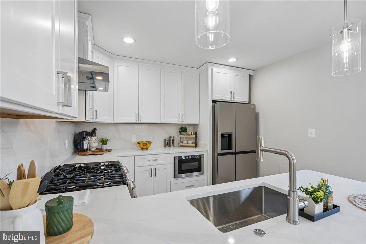 17 Longfellow Street Northwest Washington, DC 20011 - Photo 11 of 41 a kitchen with stainless steel appliances granite countertop a refrigerator sink and stove