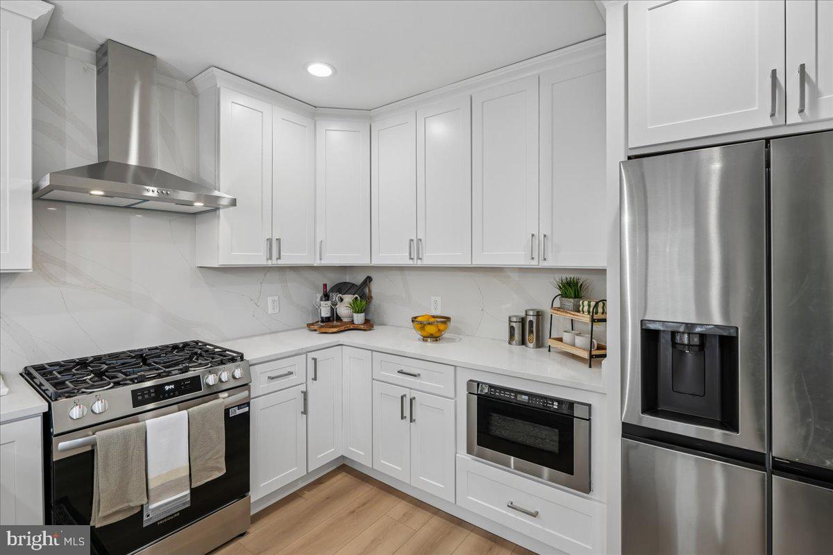 17 Longfellow Street Northwest Washington, DC 20011 - Photo 12 of 41 a kitchen with stainless steel appliances granite countertop a stove a refrigerator and a microwave