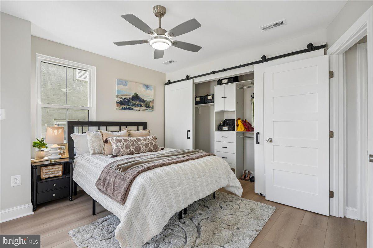 17 Longfellow Street Northwest Washington, DC 20011 - Photo 18 of 41 a bedroom with a large bed and a chandelier