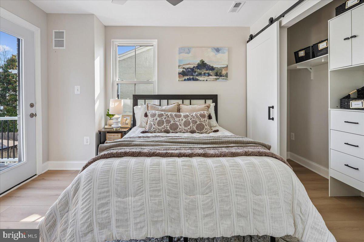 17 Longfellow Street Northwest Washington, DC 20011 - Photo 19 of 41 a bedroom with a bed and a painting on the wall
