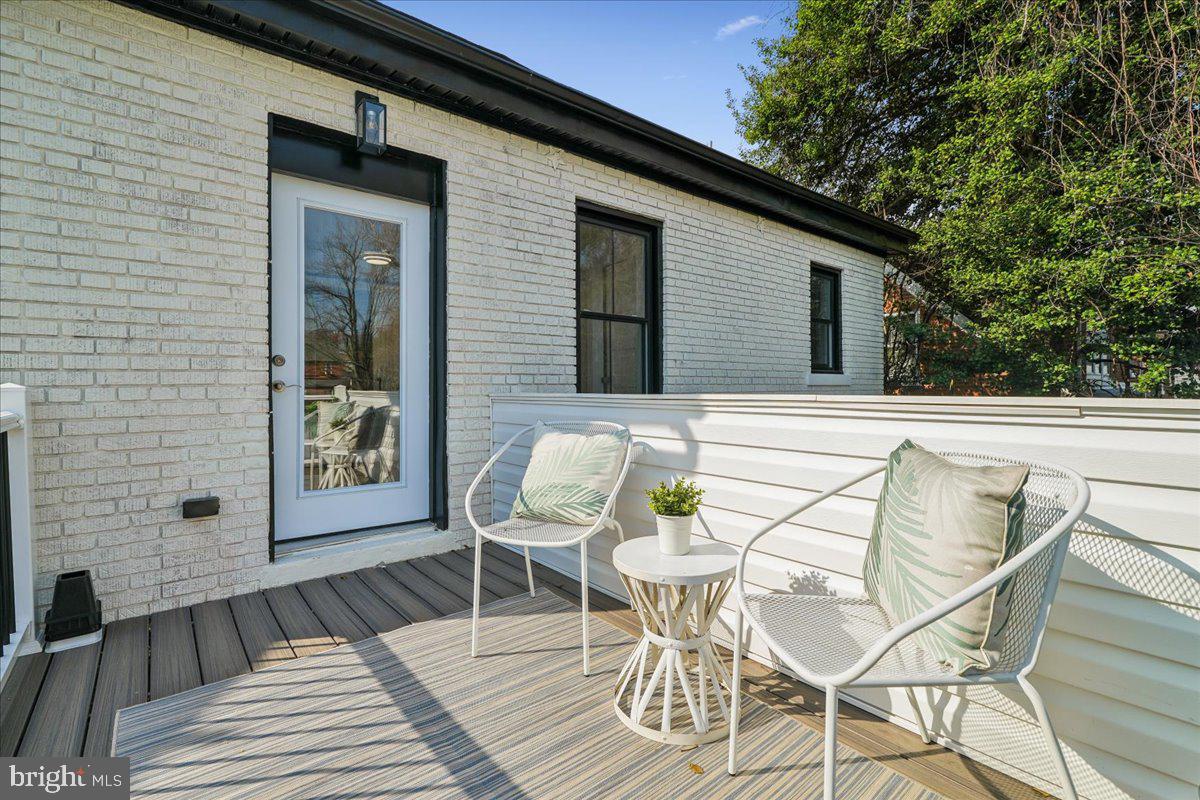 17 Longfellow Street Northwest Washington, DC 20011 - Photo 21 of 41 a view of a patio with table and chairs with wooden floor and fence