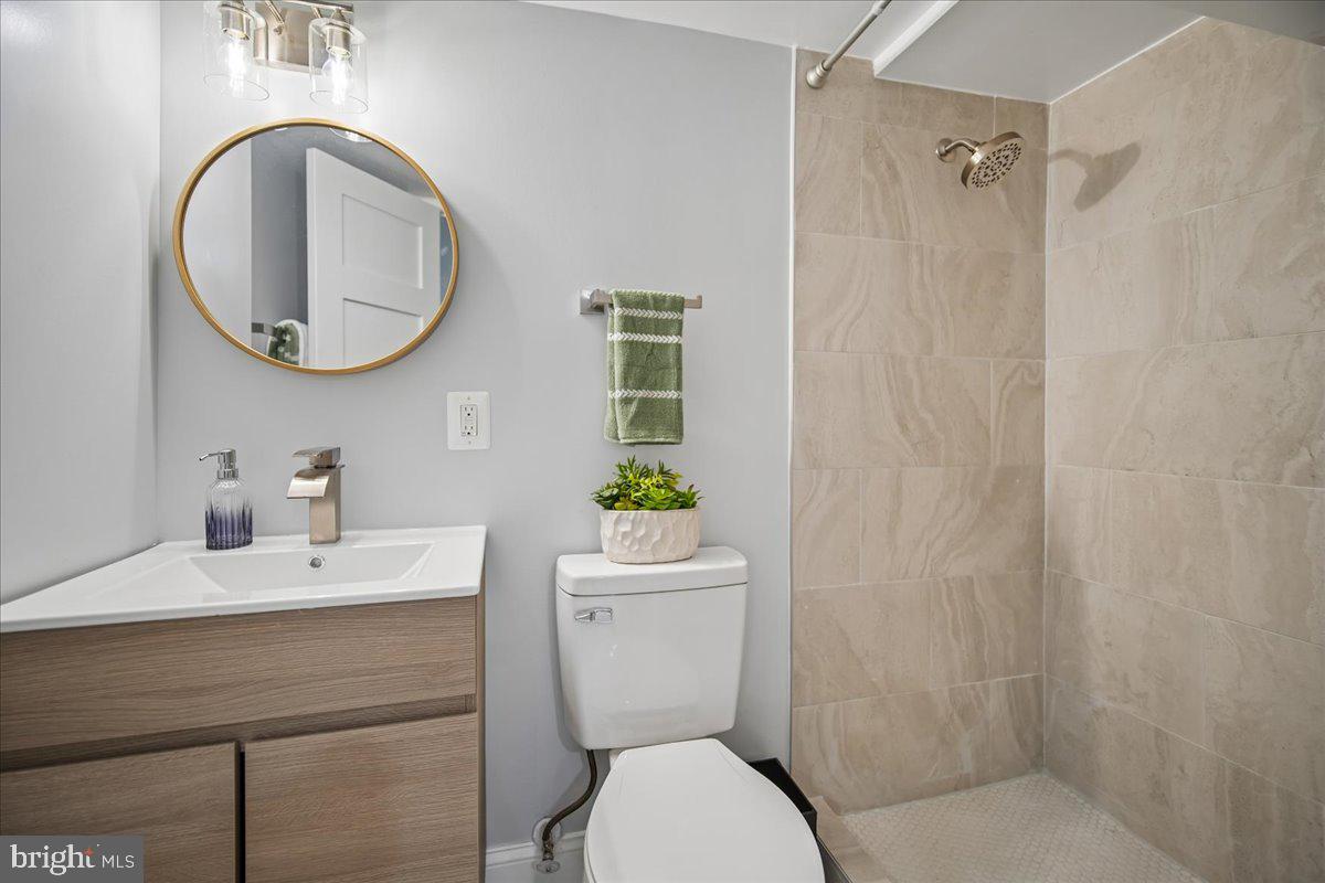 17 Longfellow Street Northwest Washington, DC 20011 - Photo 27 of 41 a bathroom with a toilet a sink and mirror