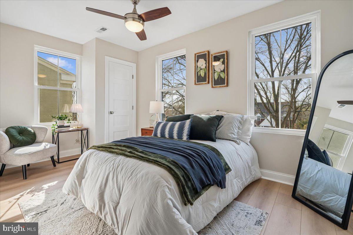 17 Longfellow Street Northwest Washington, DC 20011 - Photo 29 of 41 a bed room with a bed a couch and a painting on the wall