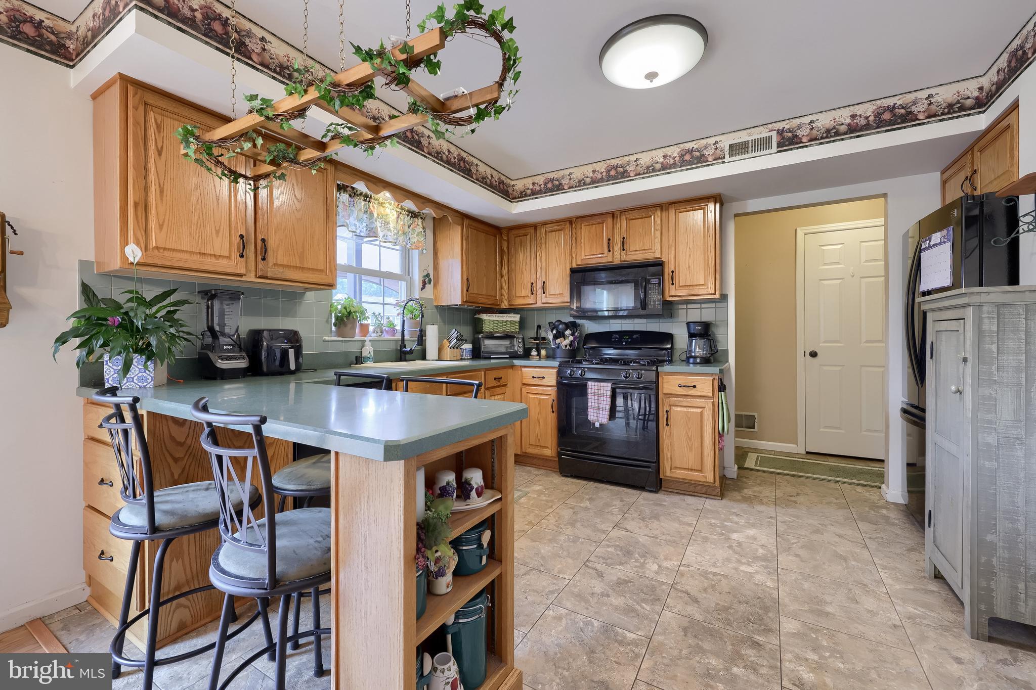 105 Bainbridge Circle Reading, PA 19608 - Photo 11 of 36 a kitchen with stainless steel appliances granite countertop a stove cabinets and a dining table