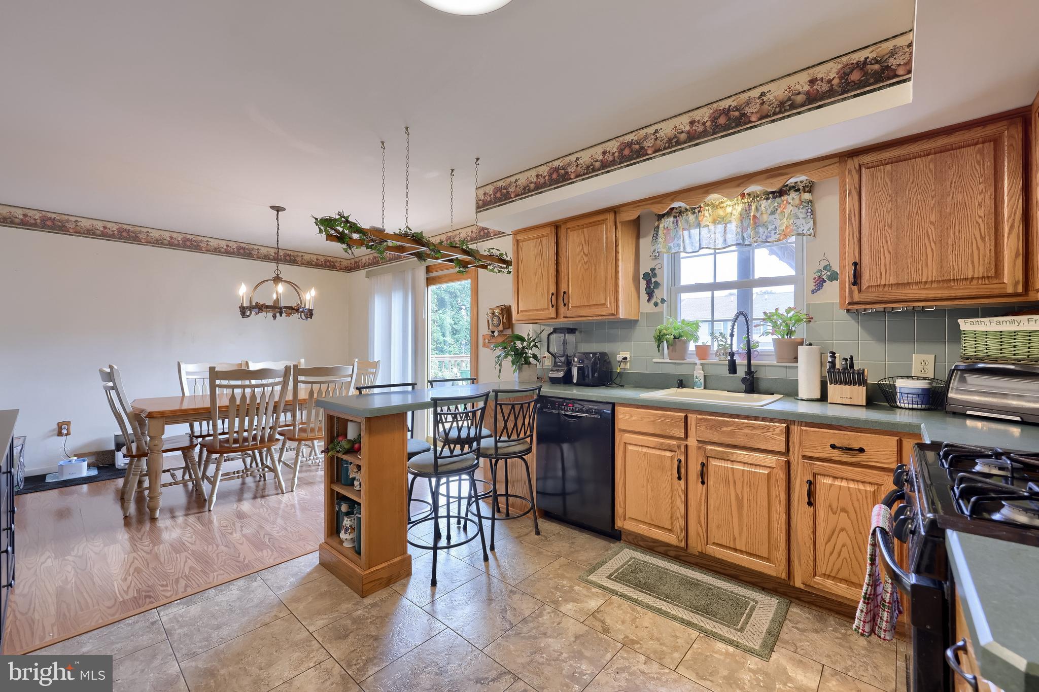 105 Bainbridge Circle Reading, PA 19608 - Photo 14 of 36 a kitchen with stainless steel appliances granite countertop a table chairs and a refrigerator