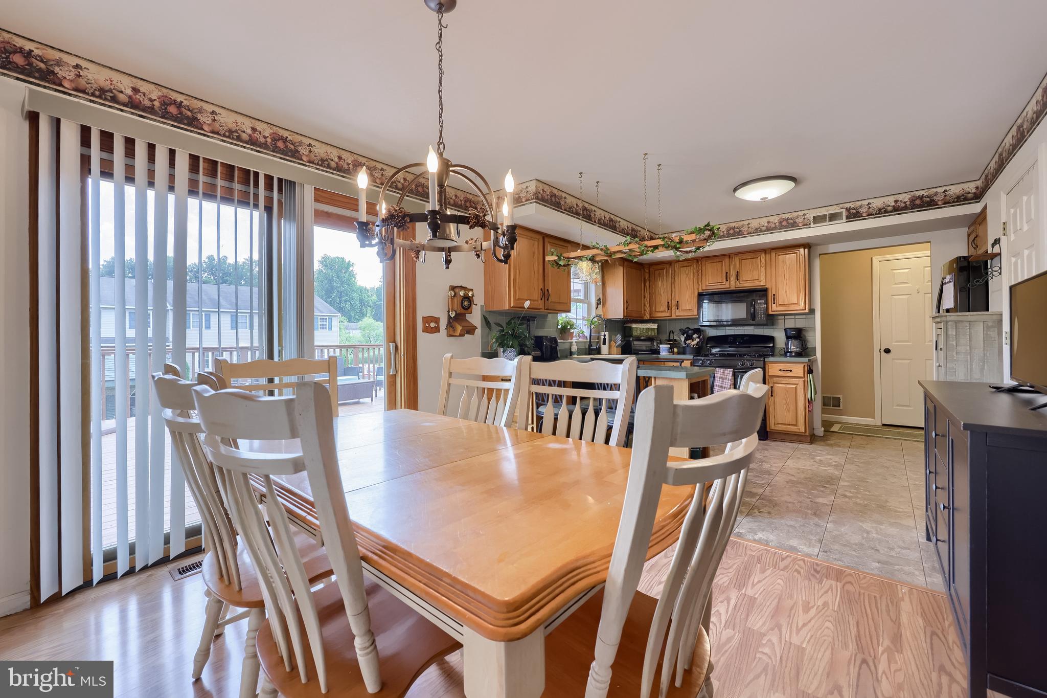 105 Bainbridge Circle Reading, PA 19608 - Photo 16 of 36 a view of a dining room and livingroom with furniture wooden floor a chandelier