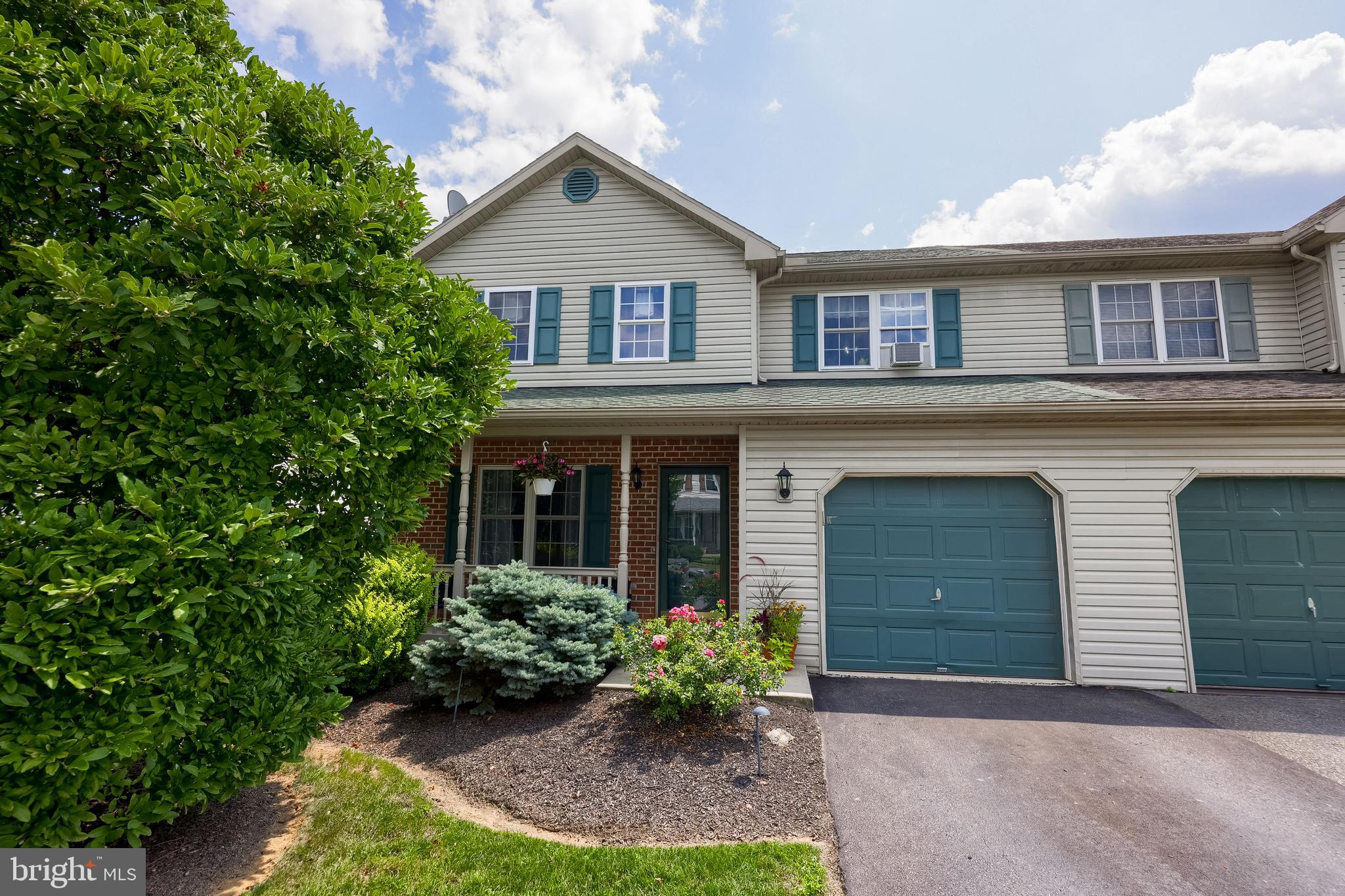 105 Bainbridge Circle Reading, PA 19608 - Photo 2 of 36 a front view of a house with a garden and plants