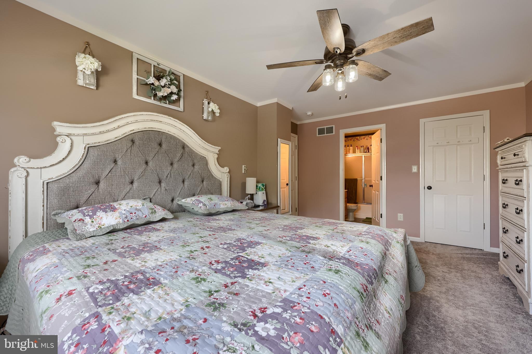 105 Bainbridge Circle Reading, PA 19608 - Photo 22 of 36 a bedroom with a bed and a chandelier