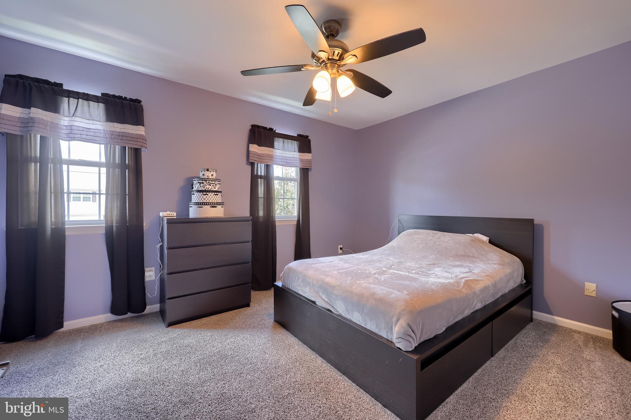 105 Bainbridge Circle Reading, PA 19608 - Photo 24 of 36 a bed sitting in a spacious bedroom next to a window and a chandelier